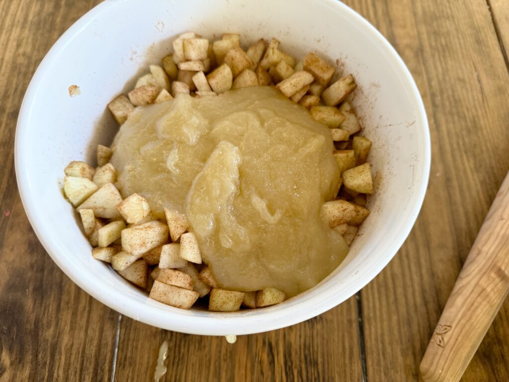 Diced apples sprinkled with cinnamon with butter and sugar poured over them