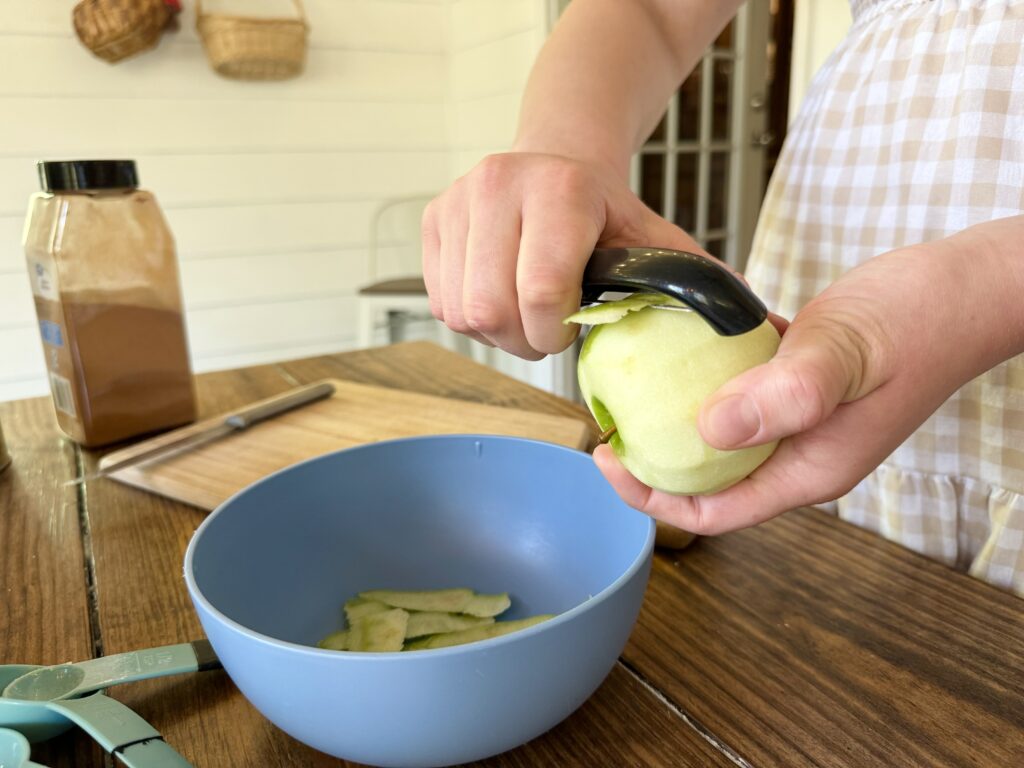 A girl peeling an apple