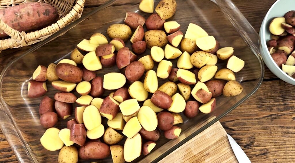 A glass pan filled with baby potatoes