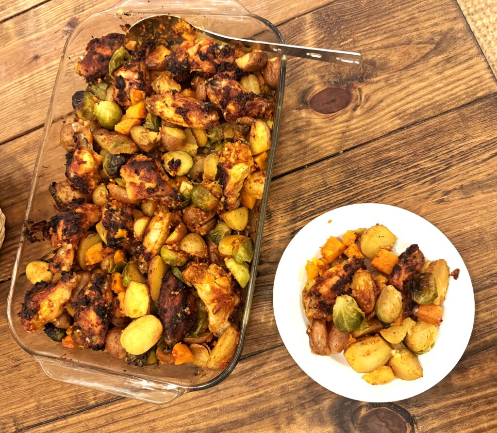 One pan and a dish filled with chicken and veggies