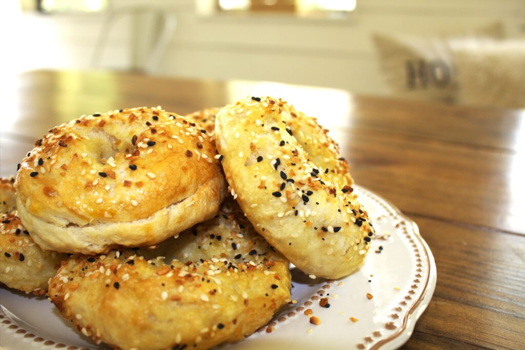 A table holding a plate with homemade sourdough bagels