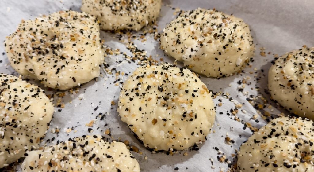 Sourdough bagels sprinkled with everything bagel seasoning.