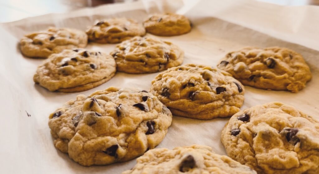 Cookies resting on parchment paper.