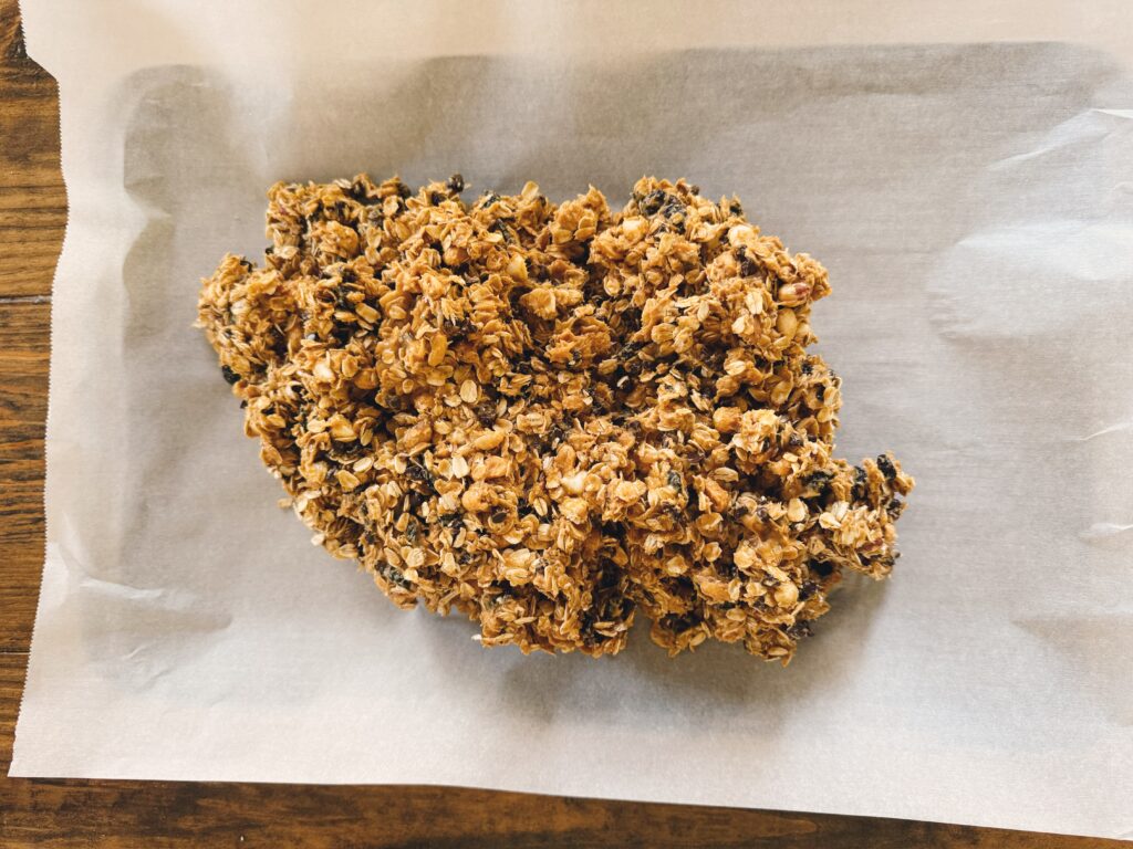 Parchment paper holding a homemade granola mixture.