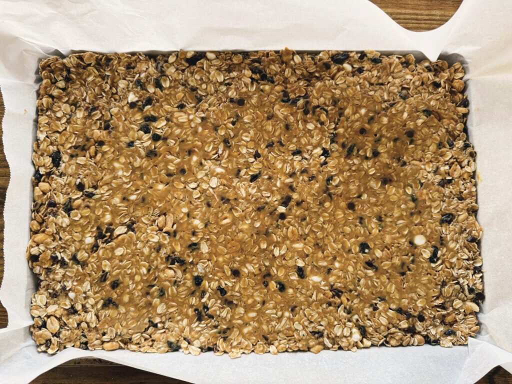 Homemade granola bar mixture on a cookie sheet.