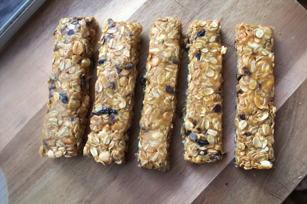 A wood table holding 5 granola bars.