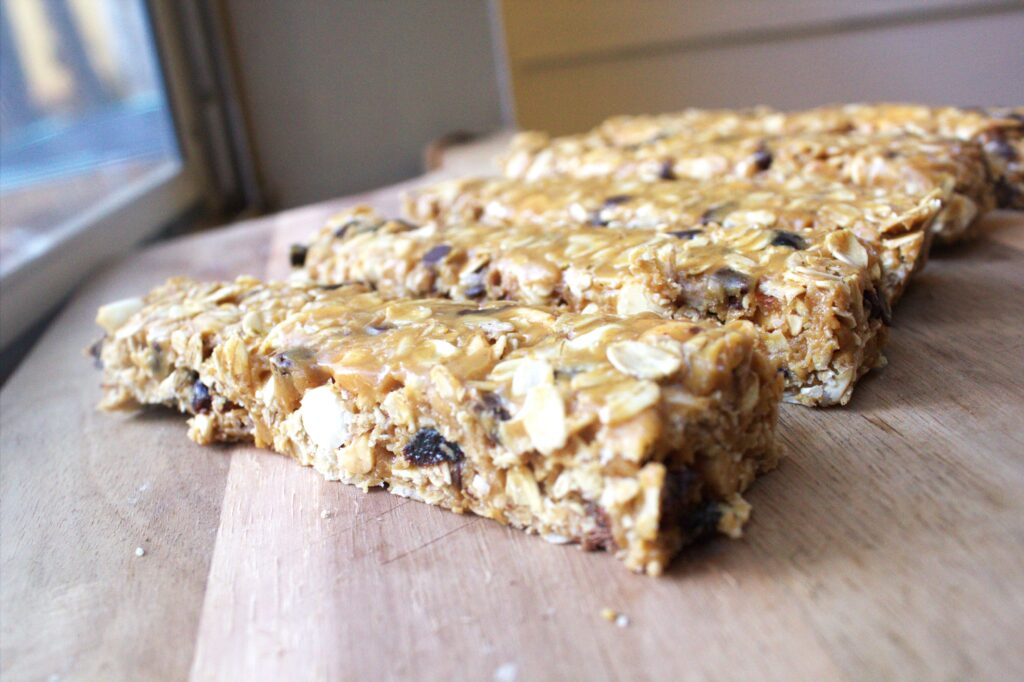 A wood table holding homemade granola bars.