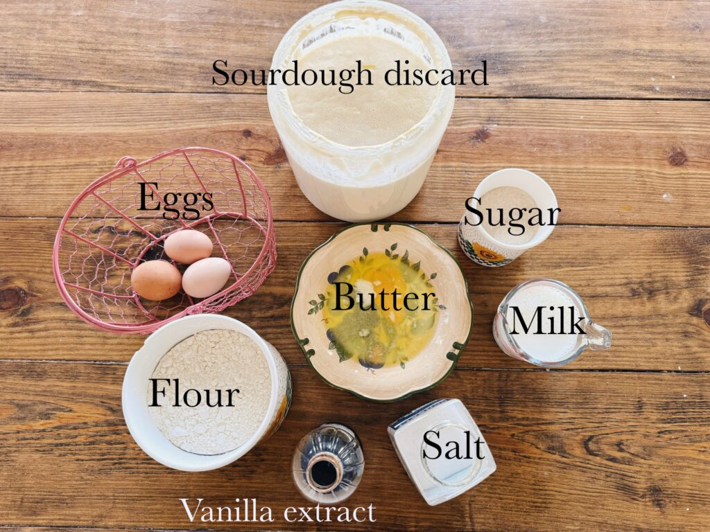 A wood table holding ingredients for sourdough crepes.